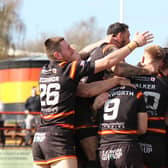 Dewsbury Rams' players wildly celebrate on their way to a stunning 32-12 win over Widnes Vikings in the fourth round of the Challenge Cup.