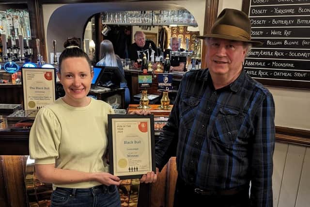 The Black Bull's Lina James presented with the pub's CAMRA award.