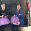 Kath Cooke from Slimming World and Melanie Smiles, Community Champion for Tesco, loading the bags to be donated to Cancer Research UK