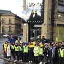 Pupils and staff from Warwick Road Primary School, Batley,  outside Mr Ts restaurant on Bradford Road.