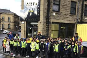 Pupils and staff from Warwick Road Primary School, Batley,  outside Mr Ts restaurant on Bradford Road.