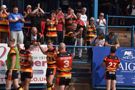 Dewsbury Rams players celebrate with their fans after Sunday's vital 22-16 win against relegation rivals Workington Town