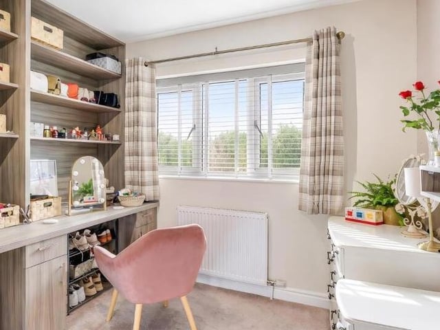 The fourth bedroom has a large fitted dressing table and desk.