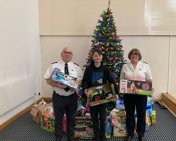 Oscar Sheard pictured with Majors Paul and Carolyn Wilson, of Batley Salvation Army, and his donations for the Christmas Present Appeal