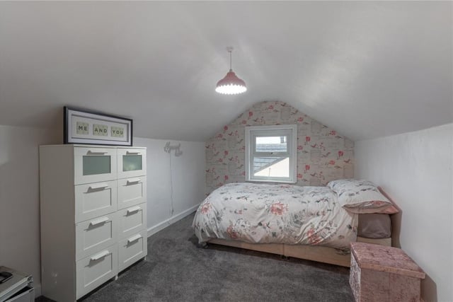 A top floor bedroom is one of two at that level, with built-in storage.