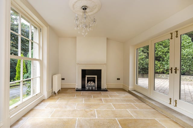 A full height sash window opens up this room, with Jerusalem stone flooring, a gas fire with granite hearth and French double doors.