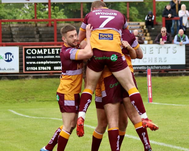 Drop-goal hero Josh Woods celebrates with Batley Bulldogs teammates as victory over Bradford Bulls is achieved. Picture: Kevin Creighton