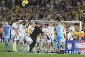 Leeds United manager Daniel Farke gets a soaking from his teammates at the end of the final game of a memorable season at Elland Road.
