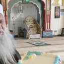 Mr. Haji Mohammad Afzal at his local Anwaar-E-Madina Jamia Mosque holding a Ramadhan cake.