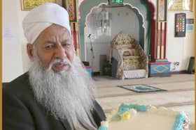 Mr. Haji Mohammad Afzal at his local Anwaar-E-Madina Jamia Mosque holding a Ramadhan cake.