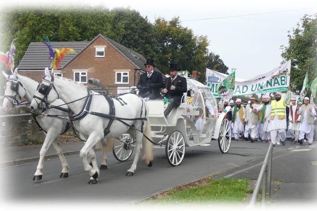 Two white stallions pulled an elegant carriage with three of the local religious leaders inside