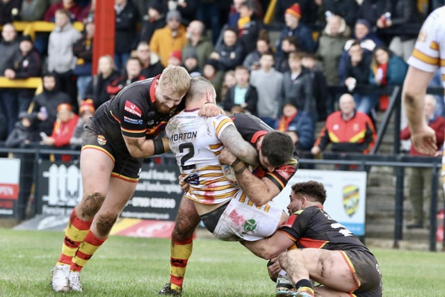 Batley's Dale Morton is tackled by three Dewsbury players.