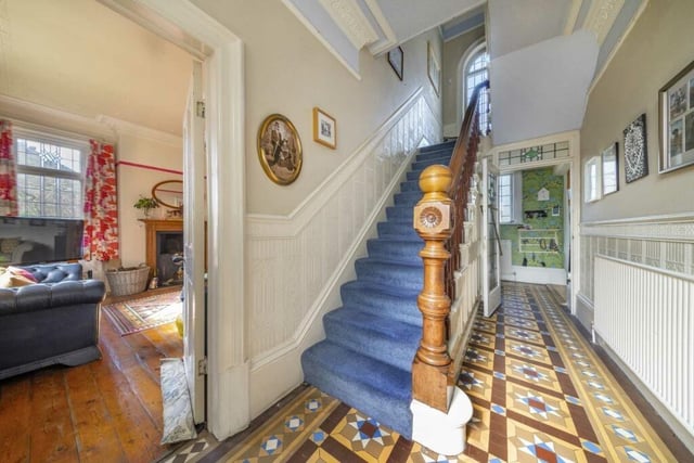 The hallway, with mahogany staircase and Victorian tiled flooring.