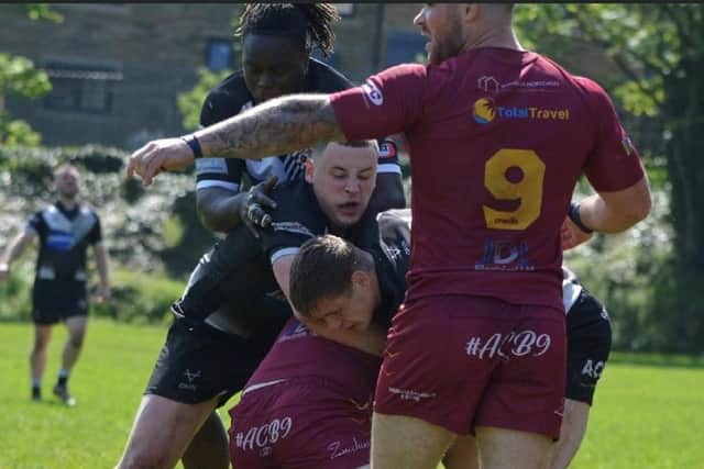 Ryan Crossley in the thick of the action for Dewsbury Moor Maroons against Saddleworth Rangers.