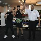 Waleed Mahmood has his arm raised after winning a Yorkshire boxing title.