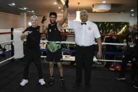 Waleed Mahmood has his arm raised after winning a Yorkshire boxing title.