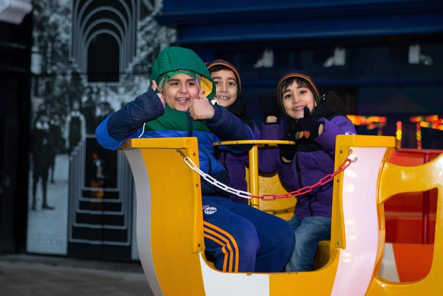 Arib, Subhan and Arban enjoying the fairground rides.