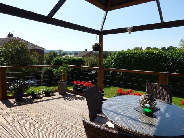 Far reaching views extend beyond the property's garden with raised decking.