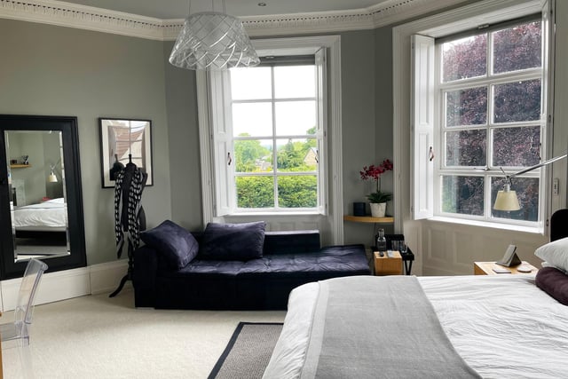 The principal bedroom has three large front windows with timber shutters and electric remote-controlled blinds. An Italian marble remote gas fire is inset to one wall, and a concealed doorway gives entry to an en-suite shower room, with Carrera Italian marble wall and floor tiles and a Duravit suite with a walk in rainfall shower, and wash basin with vanity unit.