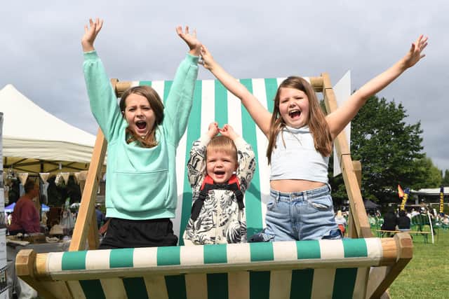Freddie Williams, Finn Sagar and Esmay Sagar on the giant deck chair at Mirfield Show. Photo: Gerard Binks