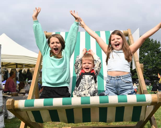 Freddie Williams, Finn Sagar and Esmay Sagar on the giant deck chair at Mirfield Show. Photo: Gerard Binks