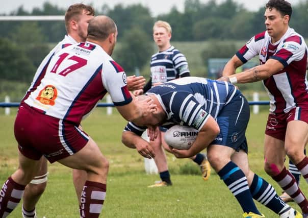 The Trojans defence are unable to prevent Danny Gilbert scoring for Featherstone Lions last Saturday.