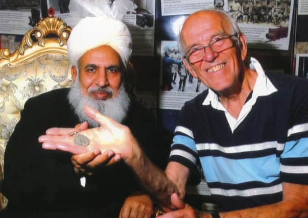 Meeting: Head Imam Qari-Hafiz Abdul Ghani (left) shows his late-fathers medal to author and lecturer Dr Bill Roberts.