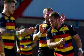 Robbie Ward is congratulated by Dewsbury Rams teammates after scoring one of his two tries in last Sundays Championship defeat to high flying Leigh Centurions. Picture: Paul Butterfield.