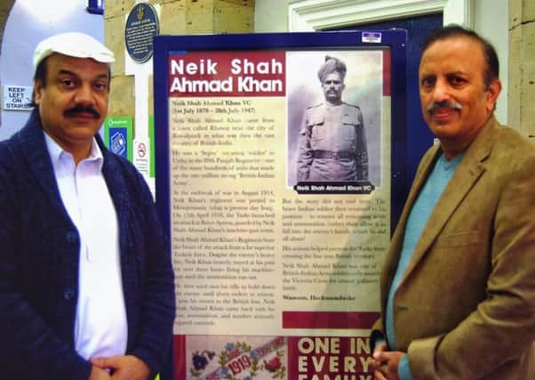 Display pride: Mosque leaders (from Left) Zamir Ahmed and Colonel Mohammad Fayum stand next to a One In Every Family display set up at Dewsbury Railway Station.