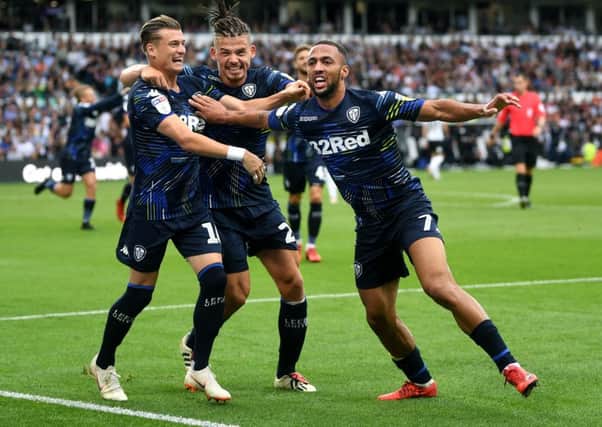 Leeds United's Kemar Roofe celebrates scoring a goal for Leeds United at Derby with teammates. Picture : Jonathan Gawthorpe