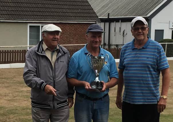M Seed (centre) defeated B Elliott to win the Heavy Woollen Parks over 55s bowls competition at Slazengers BC. Seed is pictured with  Mr A Jennings (left) from sponsors Slazengers along with Heavy Woollen Parks representative Philip Robinson.
