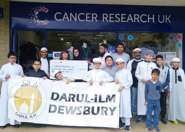 Presentation: The Darul Ilm team deliver the cheque for Â£1,150 to Cancer Research UK.