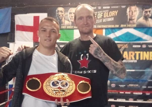 Josh Warrington and Mark Hurley with the IBF featherweight belt.