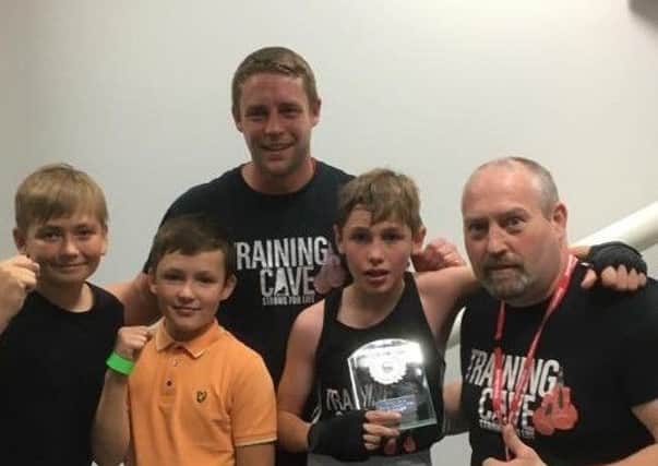 Freddie Phillips is pictured with gym mates Jack and Noah along with coaches Steven Auty and Jack Sunderland.