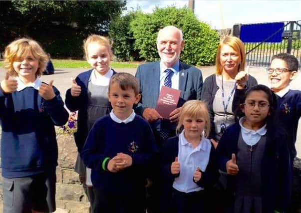 Grant: Cllr Eric Firth gives the good news to Hanging Heaton headteacher Janet Potter and pupils.