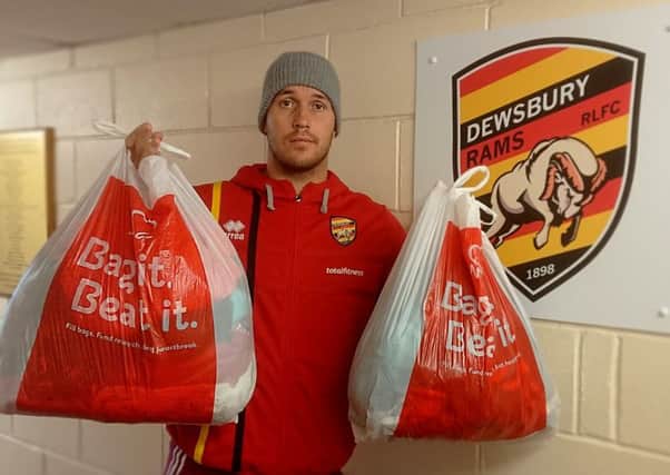 Collections: Dewsbury Rams player Lucas Wilshaw holds bags of donated items for the BHF.