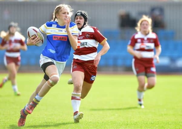 Caitlin Beevers races away from the Wigan defence to score the Rhinos third try in the Womens Super League Grand Final