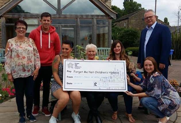 'Team Angel Gabriel' present a cheque to Forget Me Not