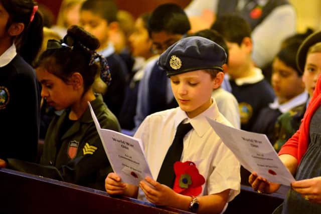 A youngster embraces the service at Batley Town Hall last year.