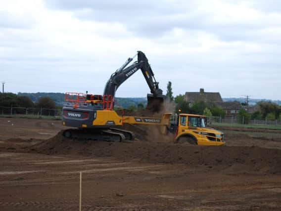 Diggers at work on fields close to Balderstone Hall.