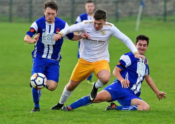 Crackenedge's Lewis Hughes attempts to battle his way through the Crofton Sports defence during Saturday's Wakefield League top of the table clash.