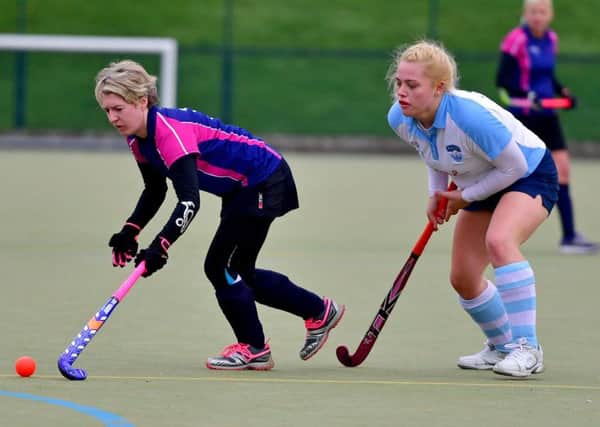 Cleckheaton's Ashleigh Hallas tries to evade a challenge from Batley's Suzy Hudson during last Saturday's ladies hockey derby.