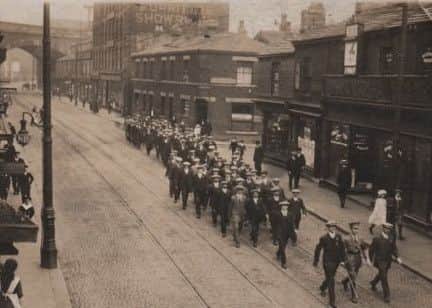 Town March: The picture shows a group of Batley volunteers at the outset of war marching through Dewsbury, probably to the recruiting station in Dewsbury Town Hall. Bickers store is on the left of picture and far right is the Railway Hotel. Picture kindly loaned by Ronnie Ellis.