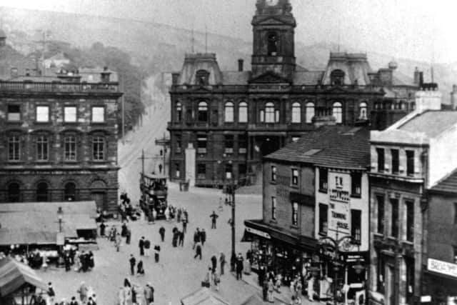 A moment in history: Market day in Market Place, Dewsbury, before the stalls were moved to the other end of town in the 1930s. There have been many big changes in Market Place over the years but the beautiful Victorian buildings still remain.