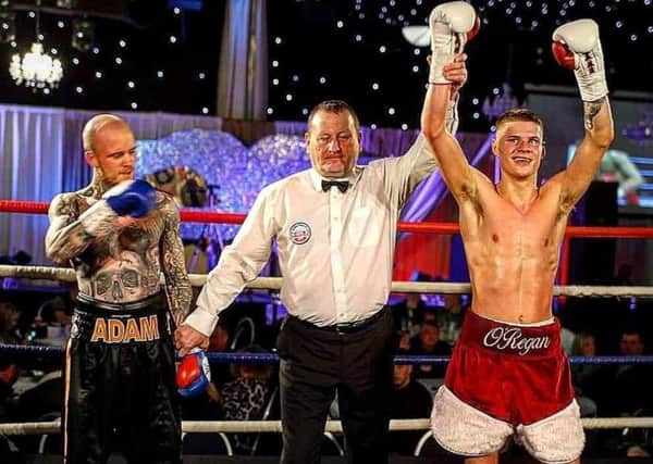 has his hand raised after securing a unanimous points win over Adam Bannister on his professional debut.