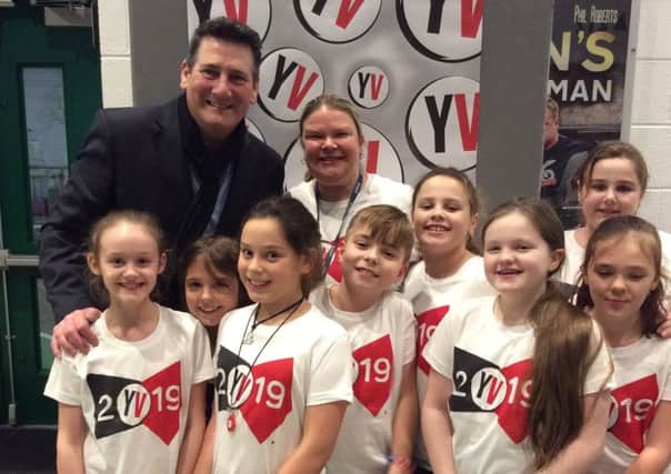 True Gent: Tony Hadley poses with Overthorpe CofE Academy pupils at the Young Voices concert.