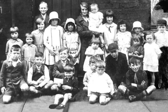 All friends together: But soon to be split up due to slum clearance. Children pictured in Halliley Street on the Flatts, Dewsbury. The picture belonged to the late Dorothy James who lived on the Flatts.