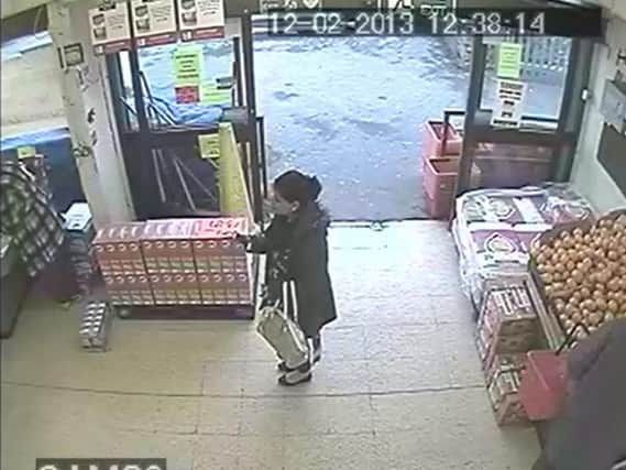 CCTV captures an unidentified accomplice snapping a picture of the misplaced juice box before Ashraf (left) turned and feigned tripping over it.