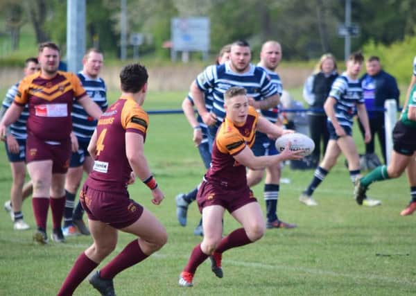 Dewsbury Moor on attack during their Division One clash against Featherstone Lions. Pic: Stevan Morton