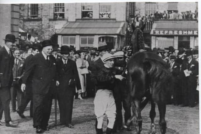 Lord Derby, carrying a stick, walks towards Tommy to congratulate him after his 1933 Derby win on Hyperion.